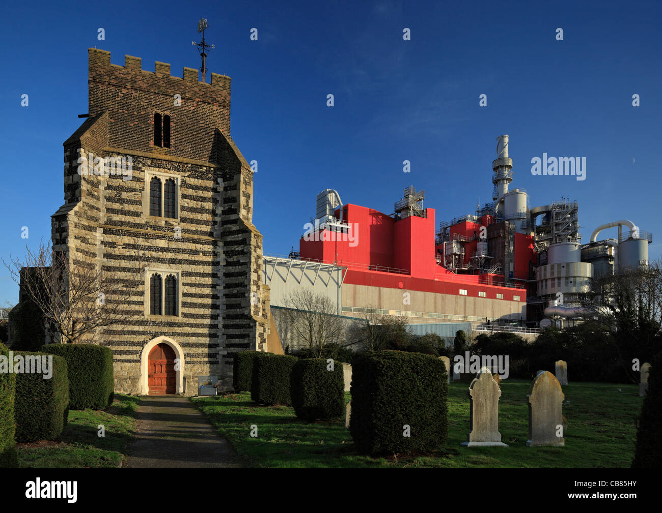 St Clements church besides the Proctor and Gamble chemical factory, West  London, Essex. Stock Photo