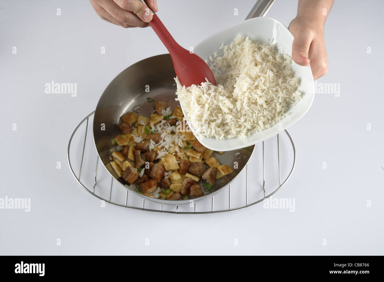 https://c8.alamy.com/comp/CB8766/adding-cooked-rice-CB8766.jpg