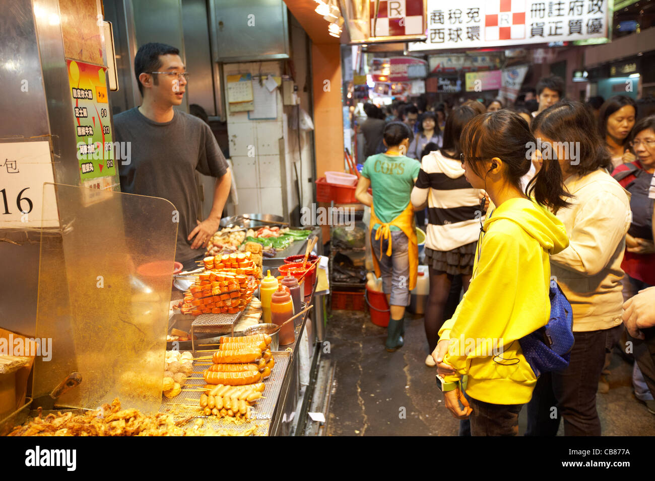 chinese people waiting at market street food stall shop cooking food hong kong island, hksar