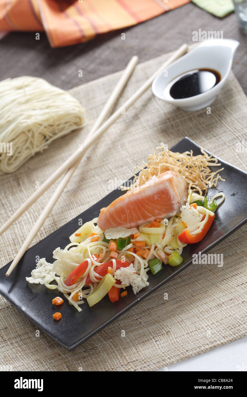 Salmon fillet with sauteed noodles Stock Photo - Alamy