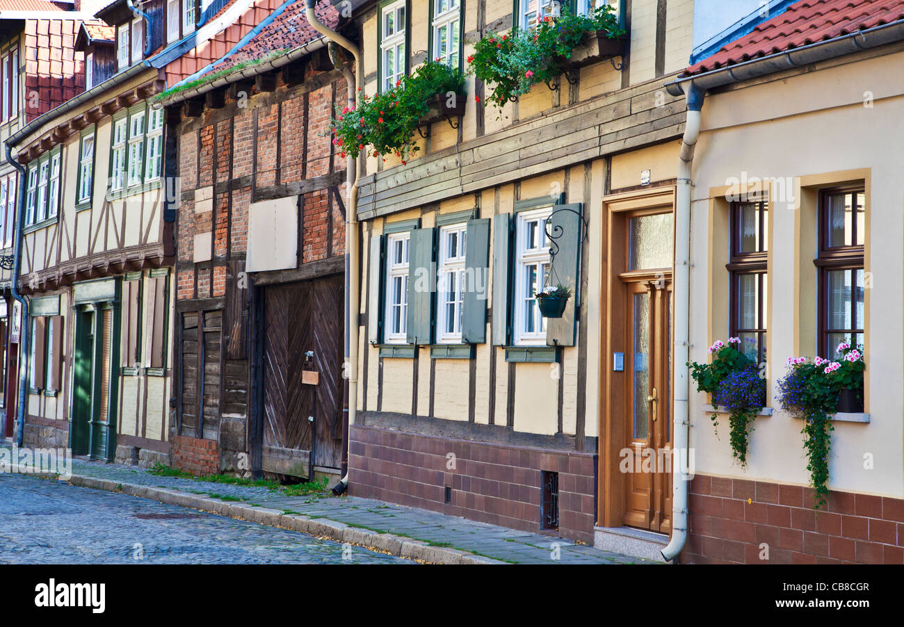 A row of half-timbered medieval houses in a cobbled street in the UNESCO World Heritage town of Quedlinburg, Germany. Stock Photo