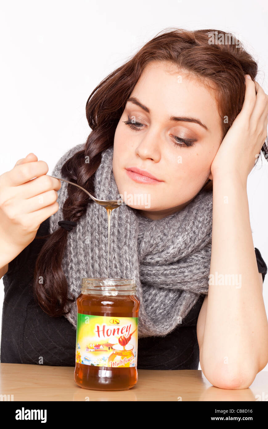 A beautiful young woman, eating honey. (CTK Photo/Rene Fluger Stock Photo Alamy