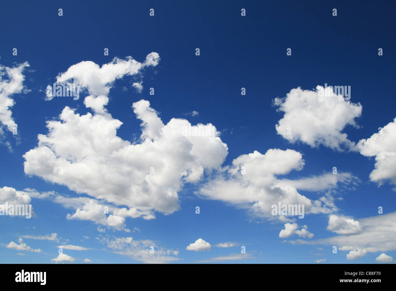 horizontal image of blue sky with puffy white clouds Stock Photo