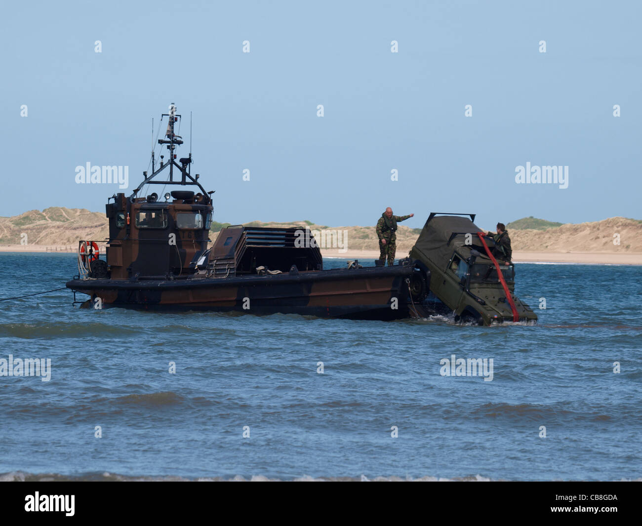 Royal marines land rover being loaded onto a landing craft, Devon, UK Stock Photo