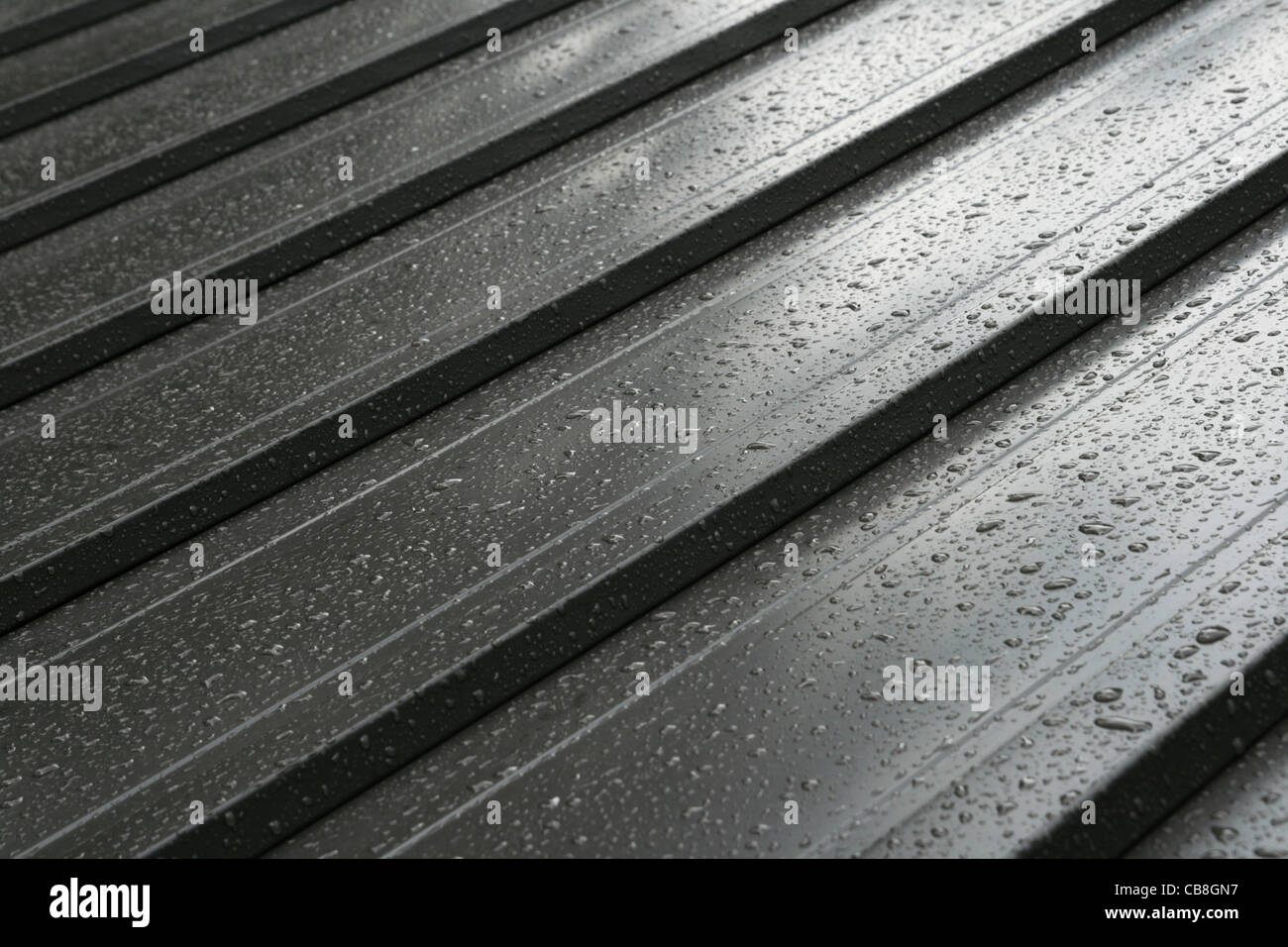 dark metal roof detail with raindrops Stock Photo