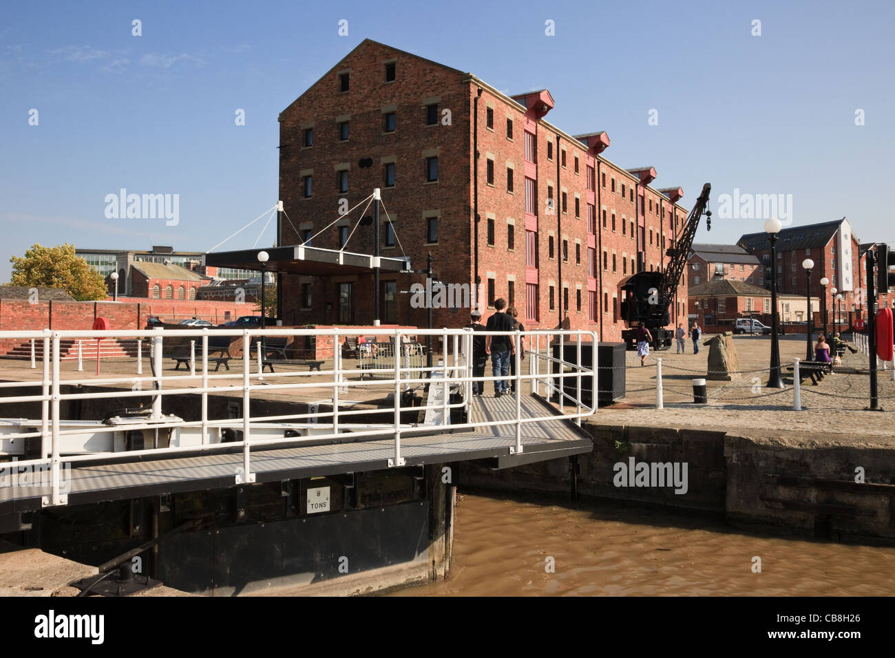 Lock gates and old warehouse building by Dock Basin. Gloucester Docks