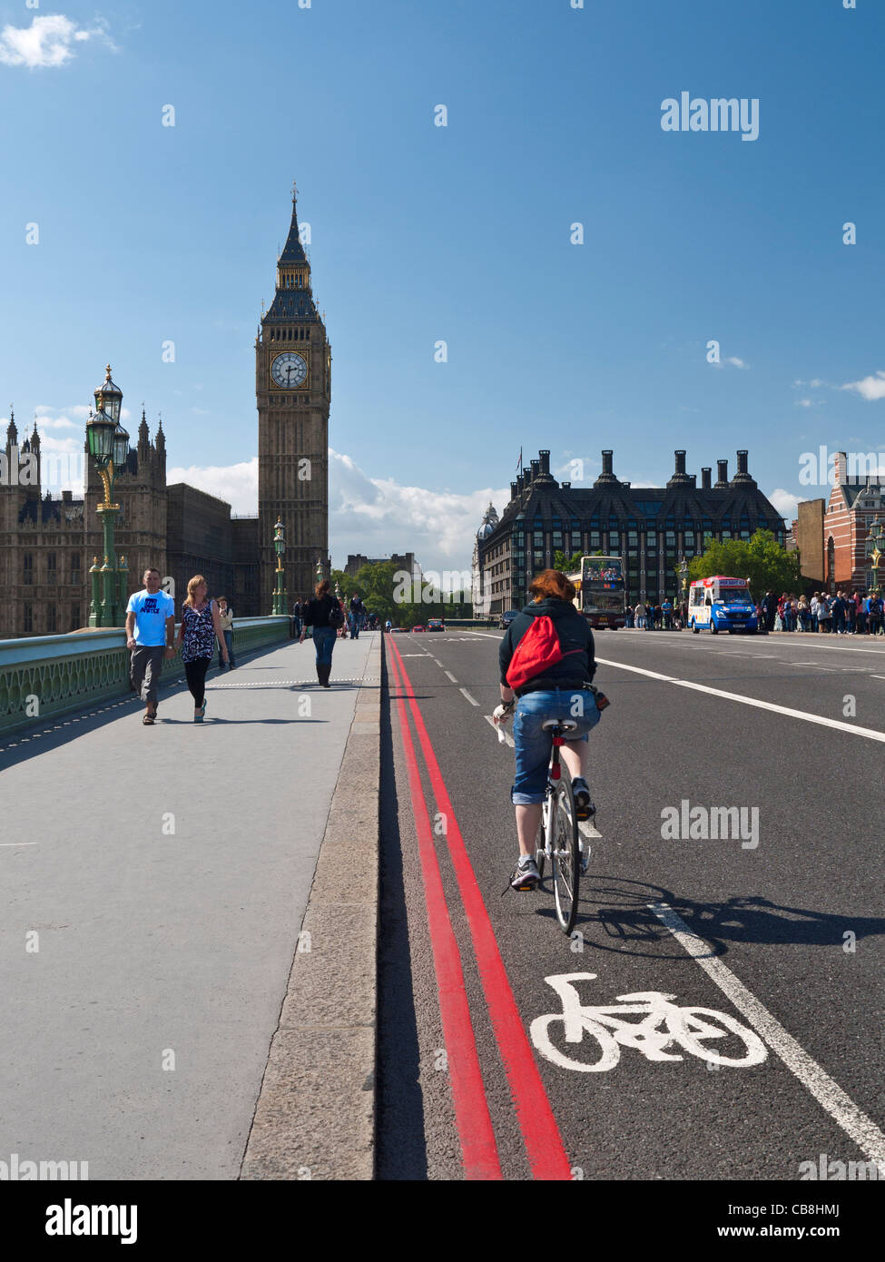 Cyclist crossing Westminster Bridge in bicycle lane Westminster London UK Stock Photo