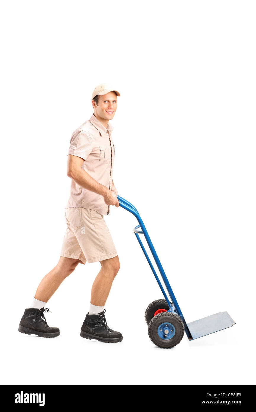 Full length portrait of a manual worker pushing an empty handtruck Stock Photo