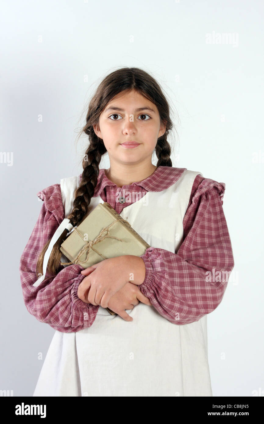 A young historical school aged student with old books Stock Photo Alamy