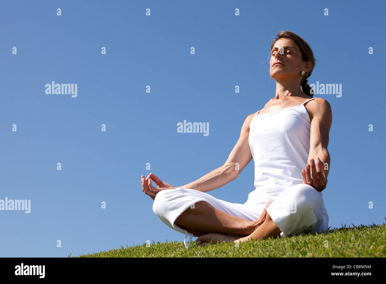 young woman enjoying nature in a yoga pose Stock Photo - Alamy