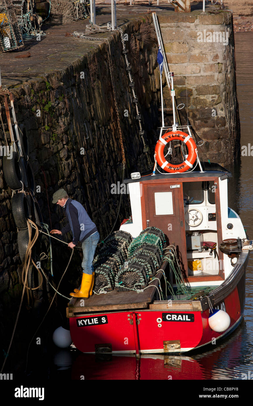 Fisherman preparing to set off to set lobster traps, Crail, East Neuk of Fife, Scotland Stock Photo