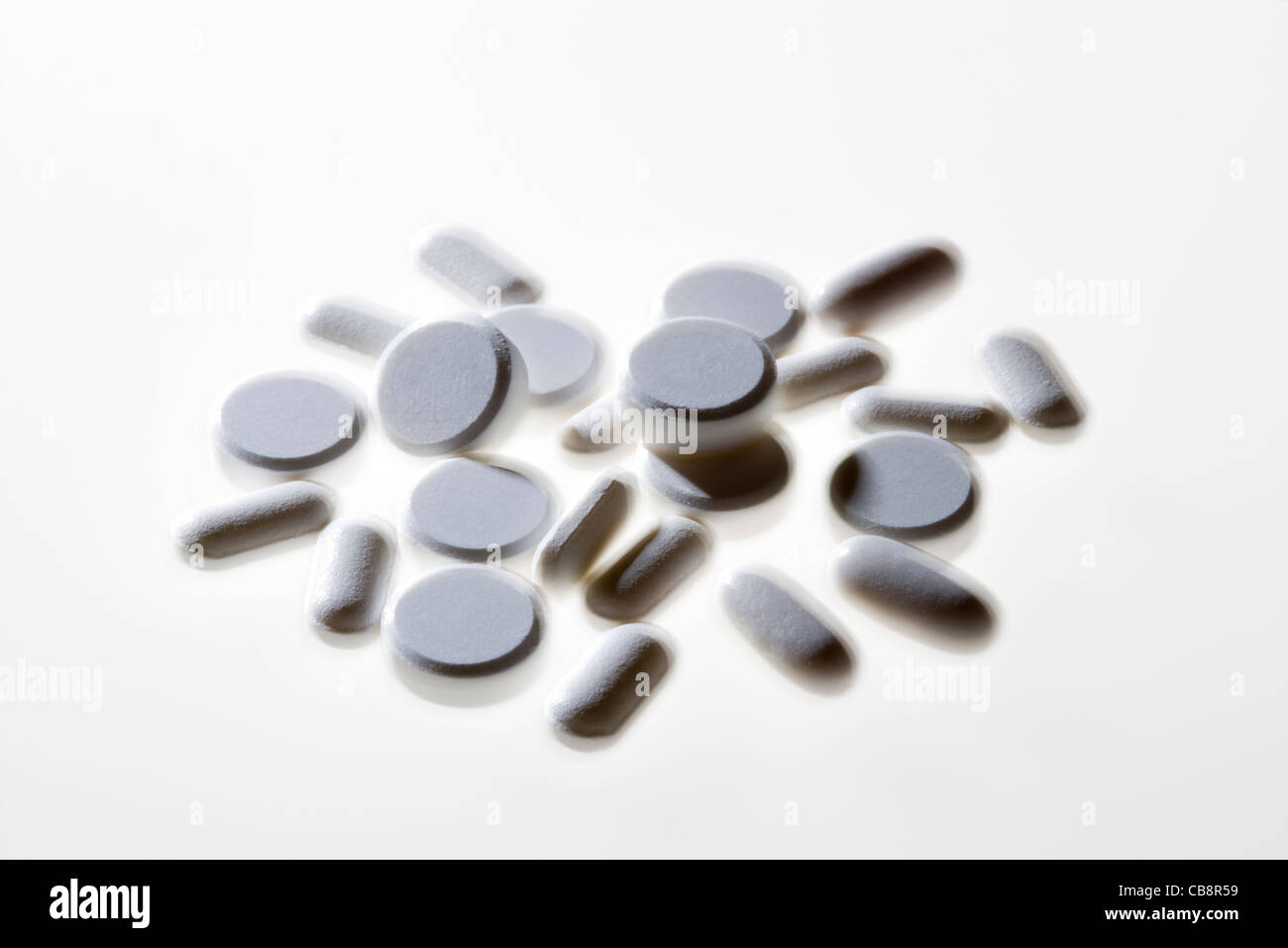 Variety of white pills. Stock Photo