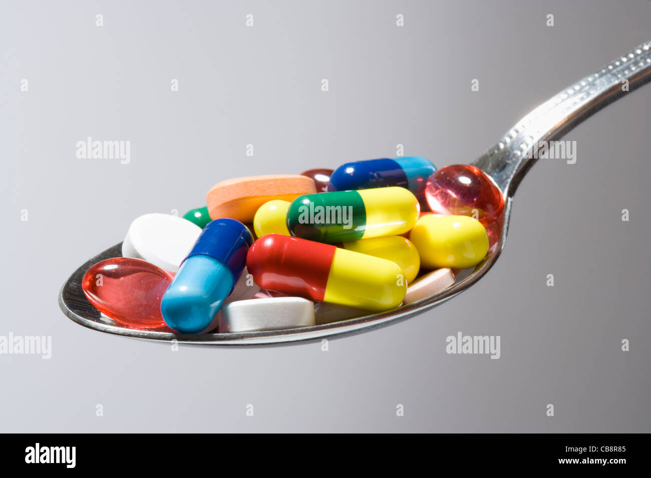 Pills on spoon. Stock Photo