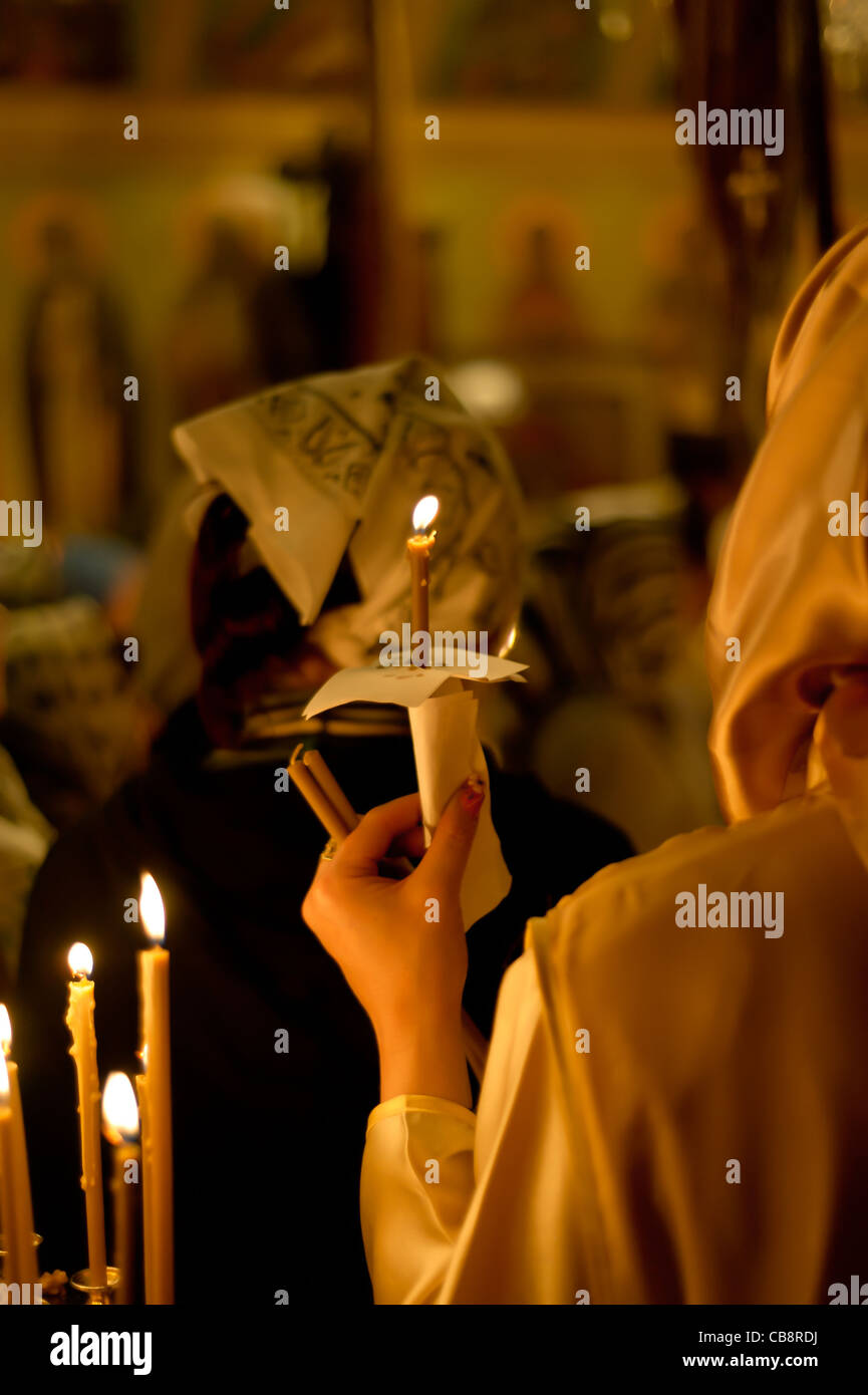 Woman with candle in a church Stock Photo Alamy