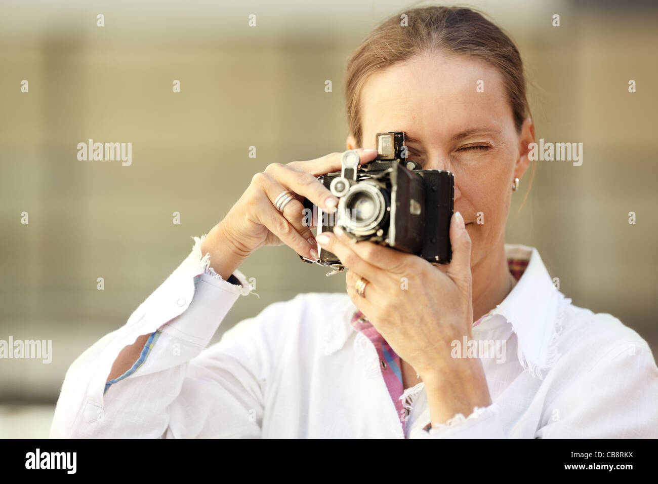 Woman with camera ,focus point on eye Stock Photo