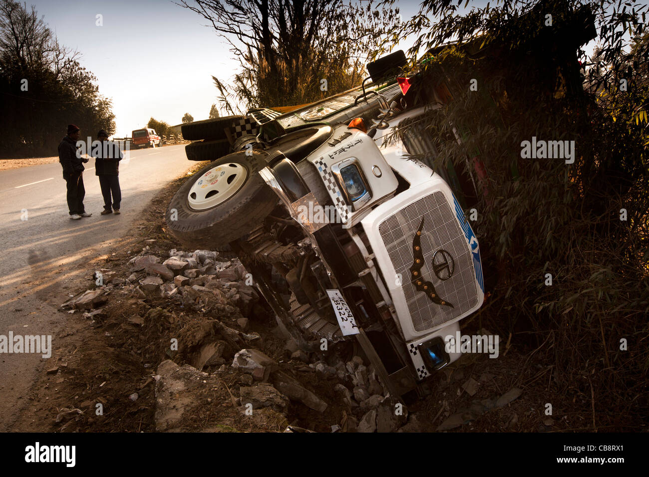 India, Meghalaya, East Khasi Hills, Cherrapunji, road traffic accident, crashed truck lying on side in ditch Stock Photo