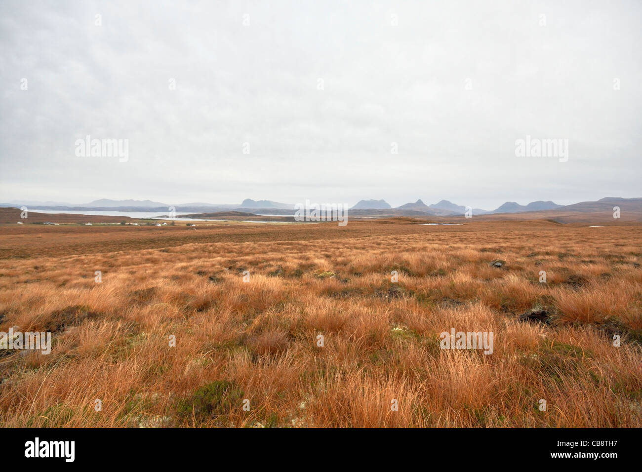 deserted panoramic scenery in Scotland with red brown grassland and distant hills Stock Photo