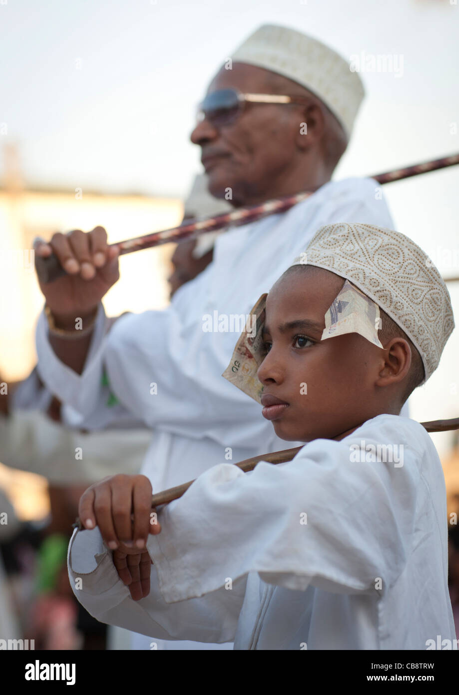 Boy And Senior Dancing Goma Stick At Maulidi Festival, Lamu, Kenya Stock Photo