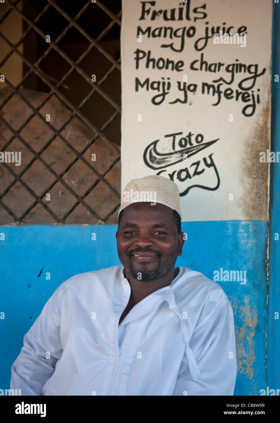 Man Muslim Sittting In Front Of A Shop, Wearing Kofia, Lamu, Kenya Stock Photo