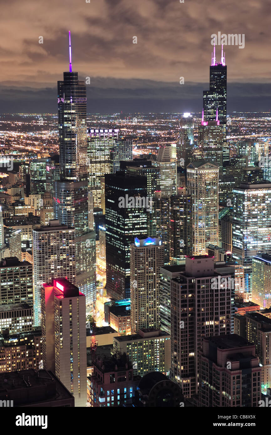 Chicago urban skyline panorama aerial view with skyscrapers and cloudy sky at dusk with lights. Stock Photo