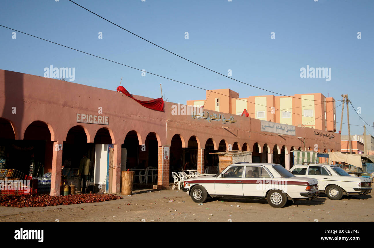 A coastal town in the Western Sahara with traditional architecture and parked cars, Morocco Stock Photo