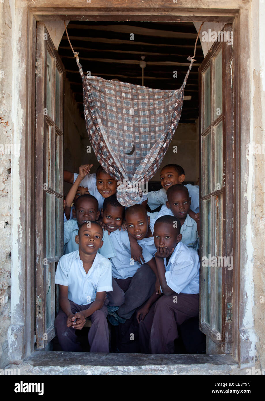 Group Of Schoolboys In The Frame Of The Classroom Stonetown Academy Lamu, Kenya Stock Photo