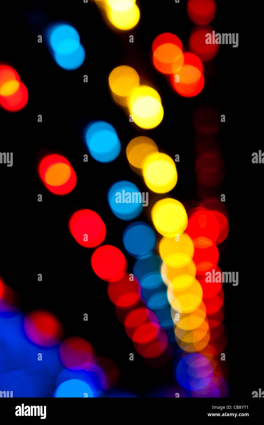 De-focused out of focus spots of coloured lights at a fairground, Stock Photo