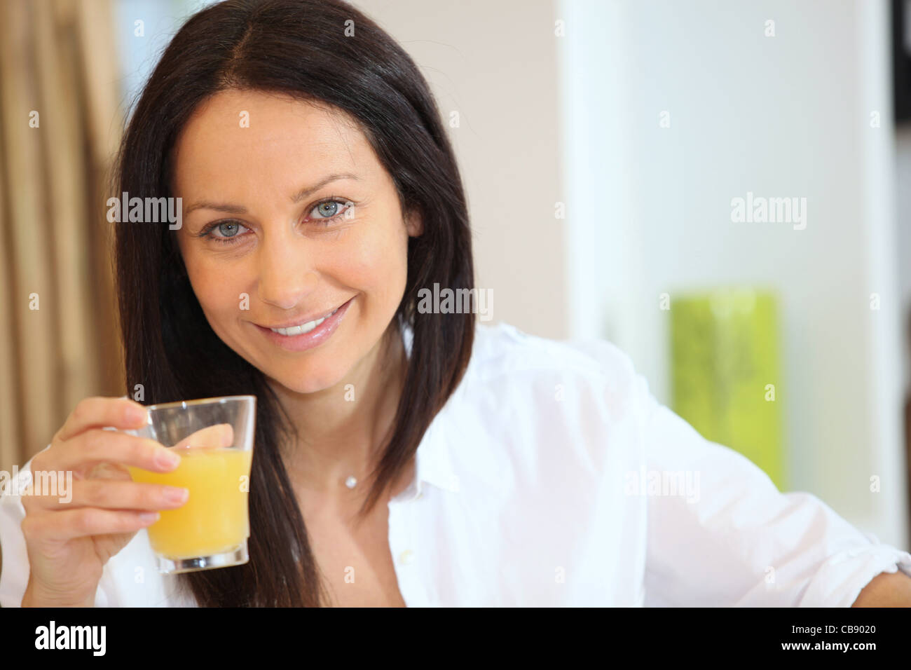 Beautiful Brunette Drinking Orange Juice Stock Photo Alamy
