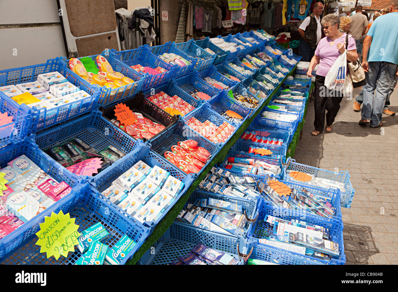Plastic crates with cheap goods on sale in outdoor market Abergavenny