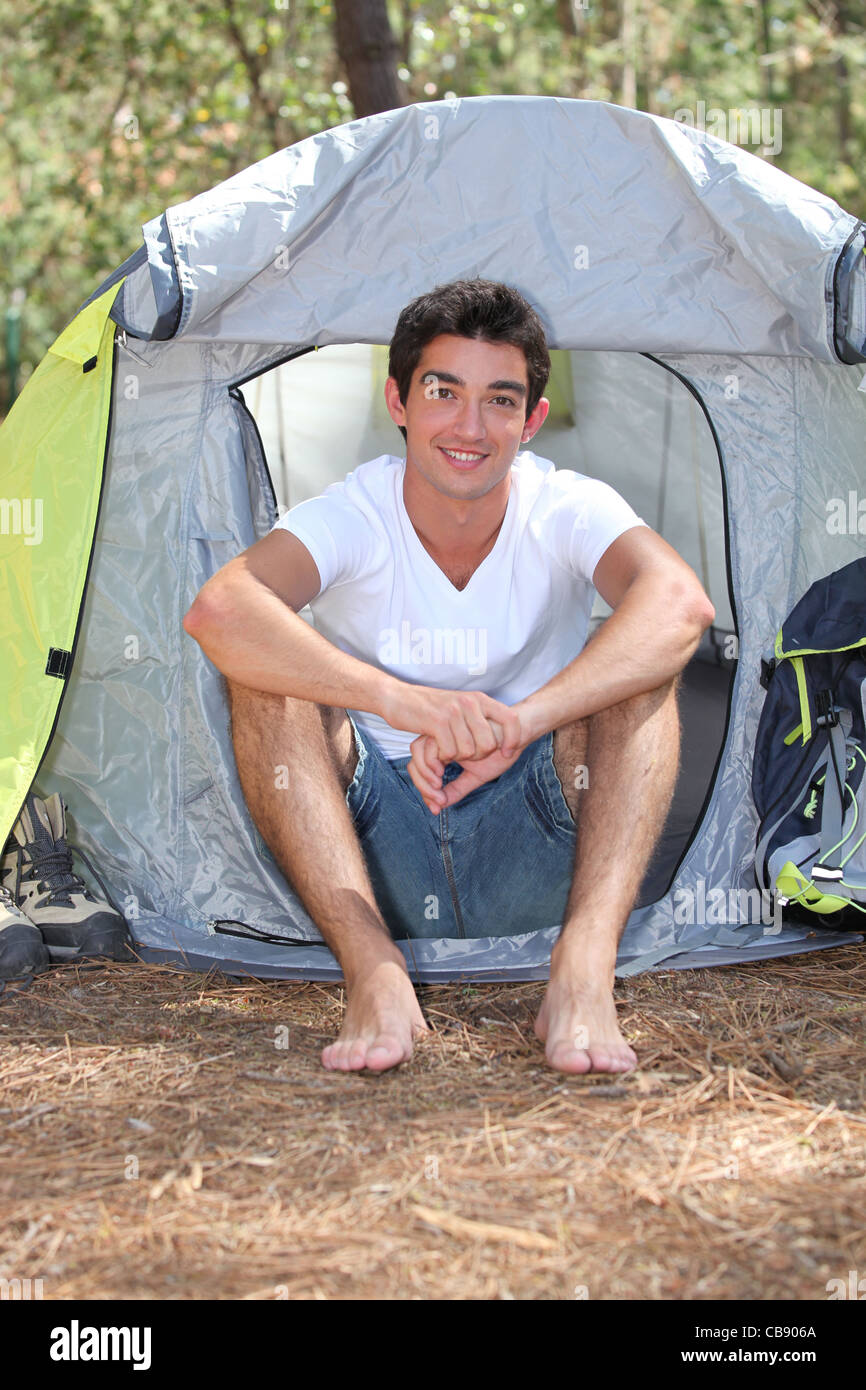 Teenage boy sitting in front of his tent on a sunny day Stock Photo - Alamy