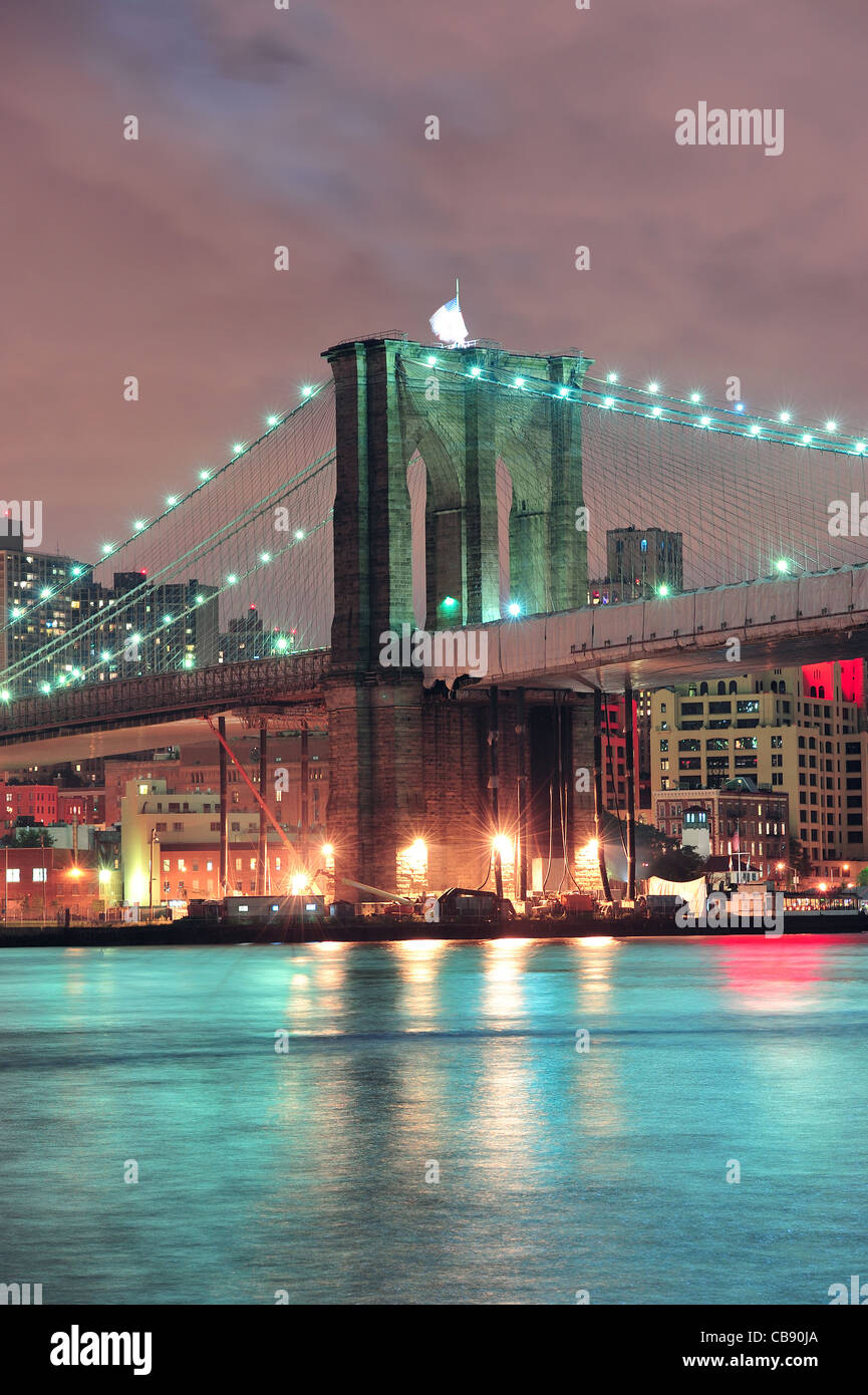 Brooklyn Bridge closeup over East River at night in New York City ...