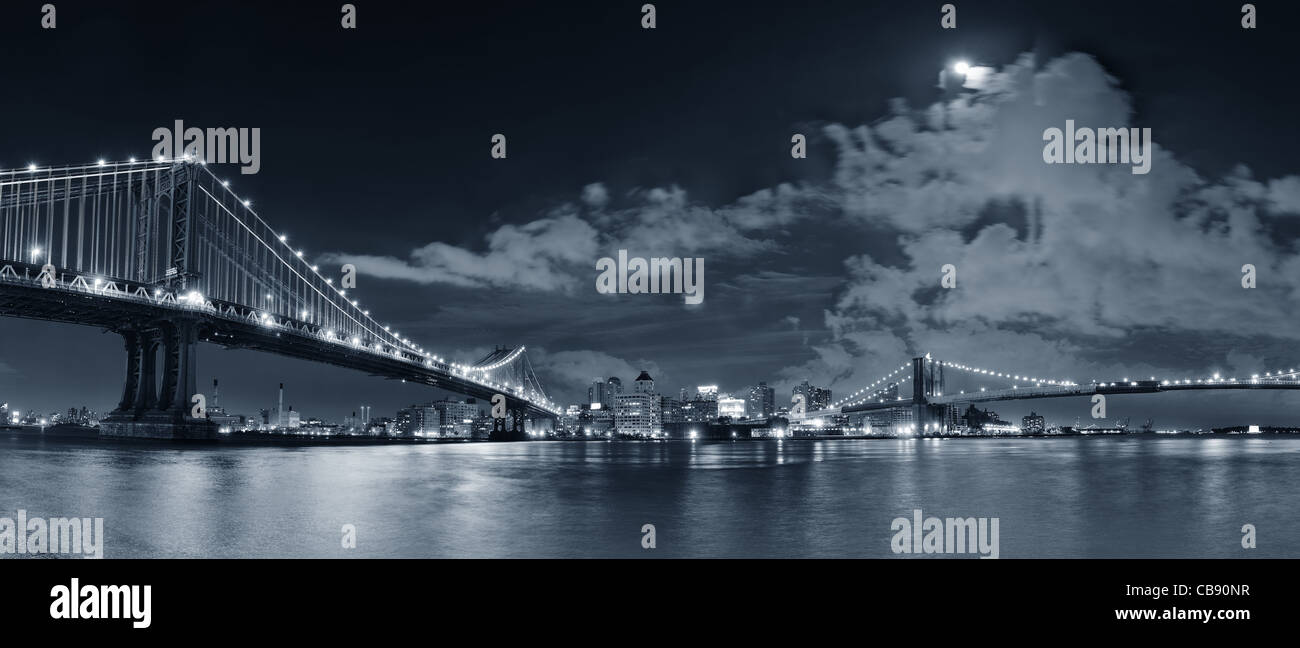 Brooklyn Bridge and Manhattan Bridge over East River at night with moon ...