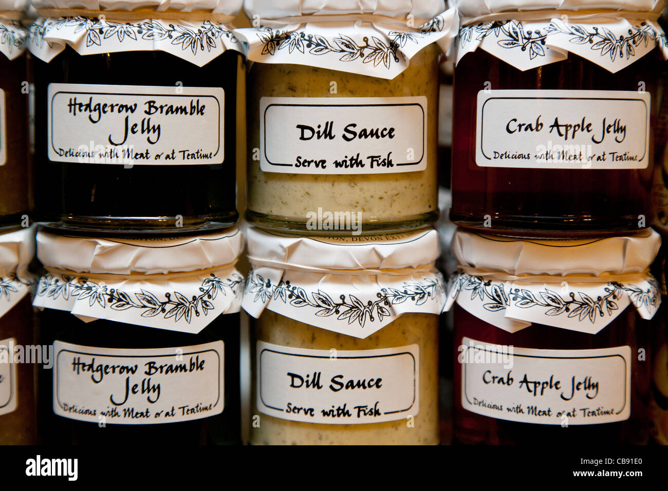Pots of home made jelly and sauce in two rows stacked on top of each other Stock Photo