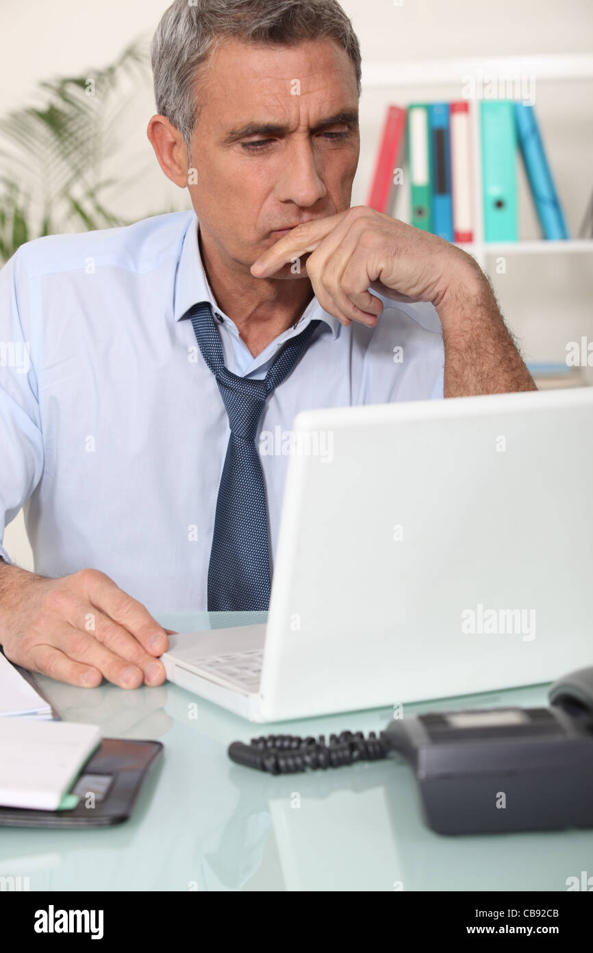 Grouchy man reading an email Stock Photo