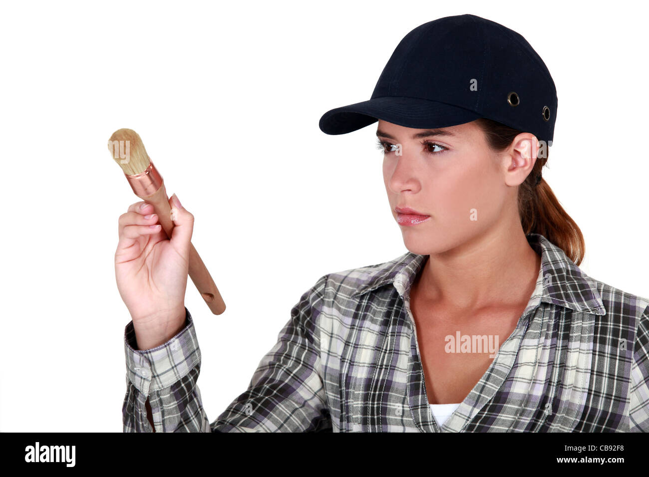 Woman holding a paintbrush Stock Photo