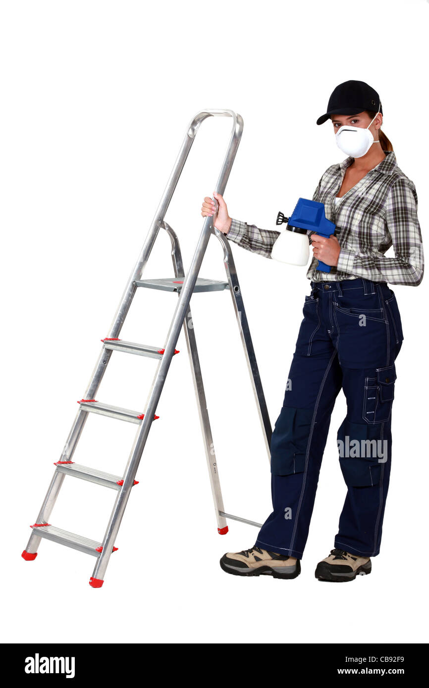 Woman stood by ladder holding spray paint Stock Photo Alamy
