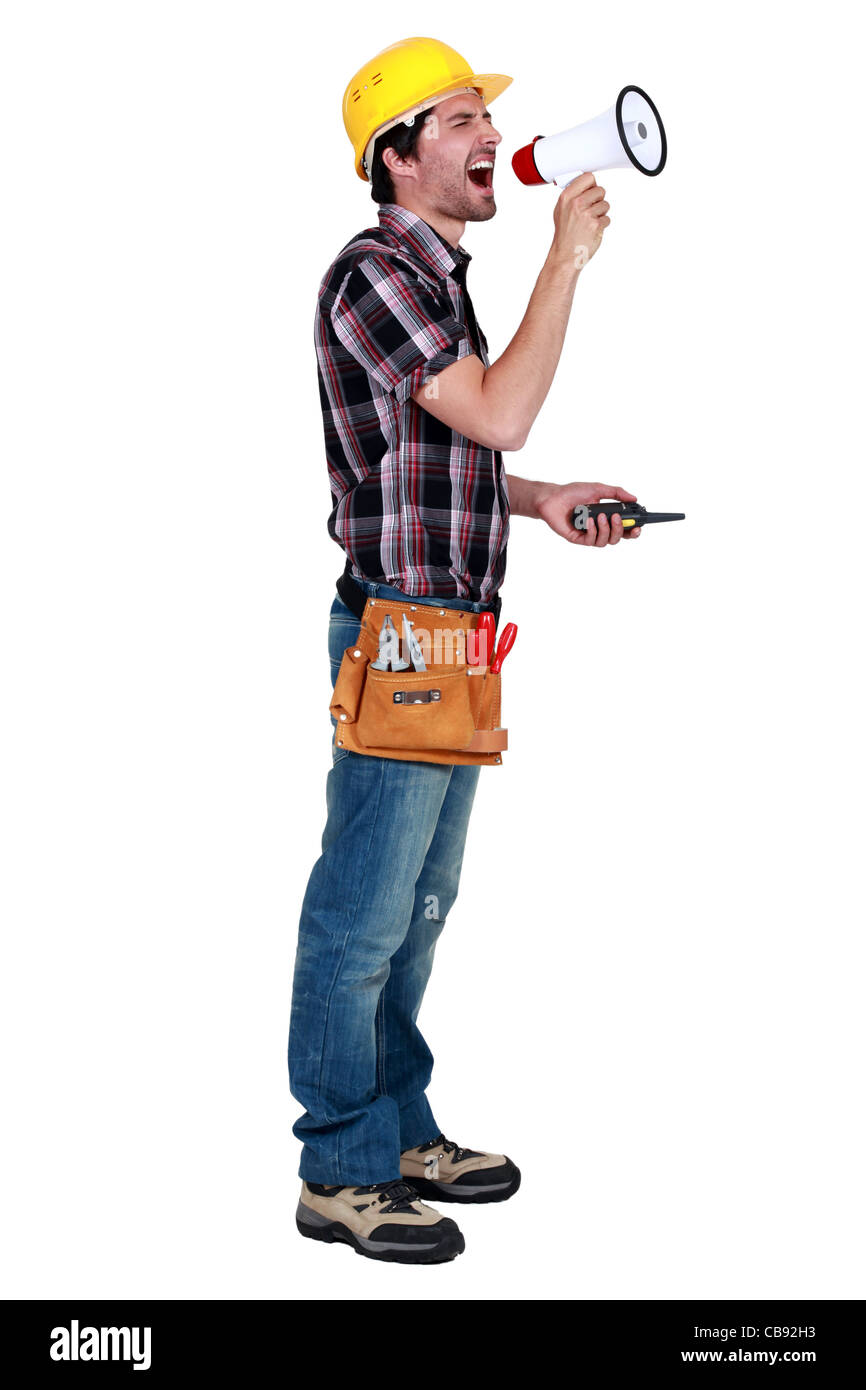 craftsman holding a walkie talkie and shouting through a megaphone Stock Photo