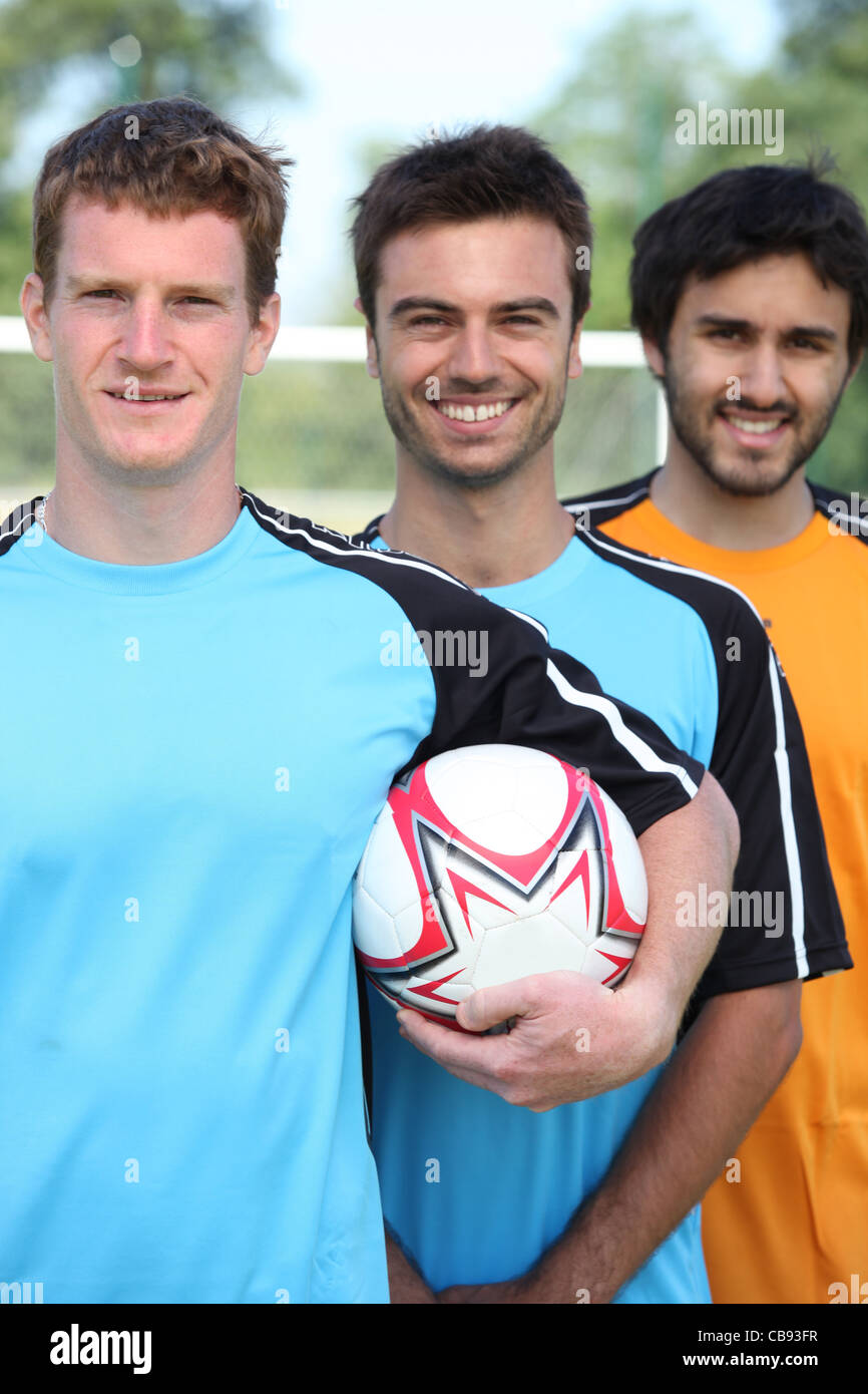 Three smiling young football players Stock Photo Alamy