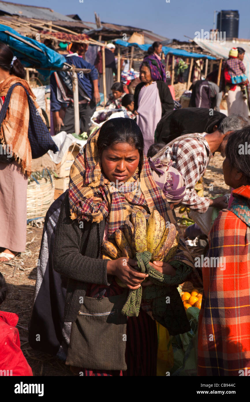 India, Meghalaya, Jaintia Hills, Shillong district, Ummulong Bazar, woman carrying large bunch of bananas Stock Photo