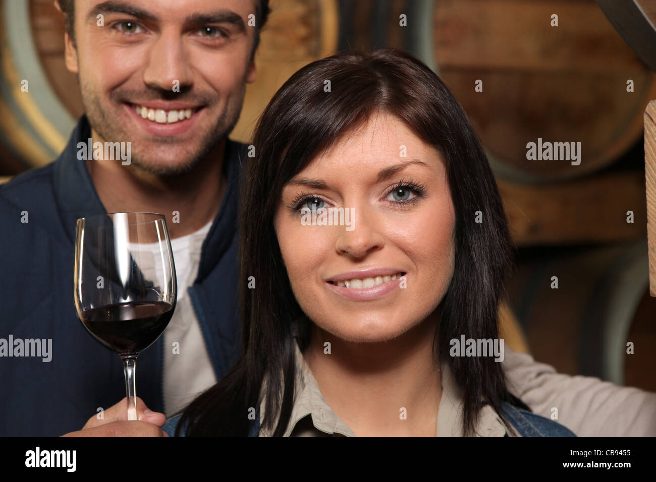 Couple drinking red wine in a cellar Stock Photo - Alamy