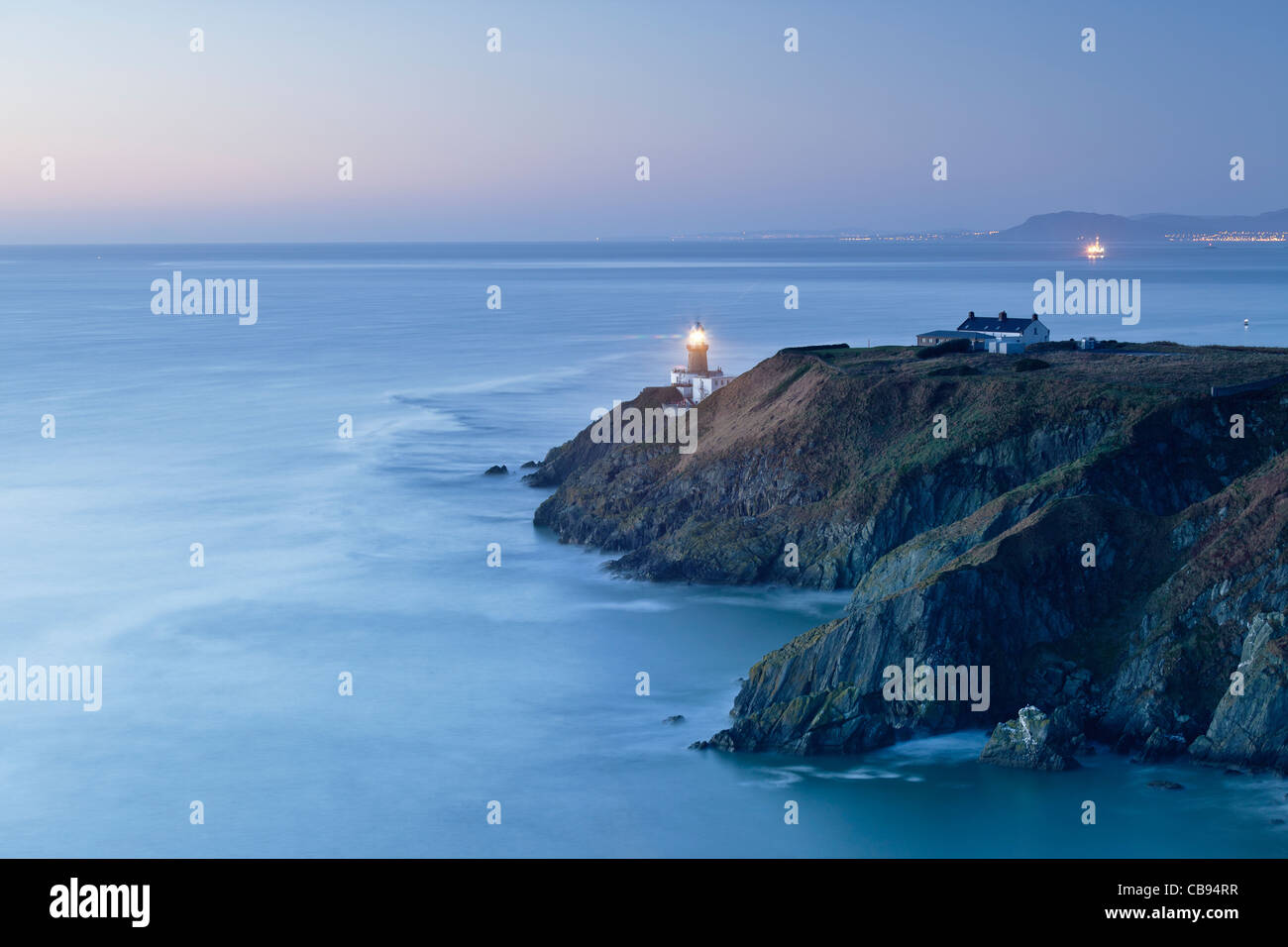 Baily Lighthouse viewed from Howth Head overlooking Dublin Bay Stock Photo