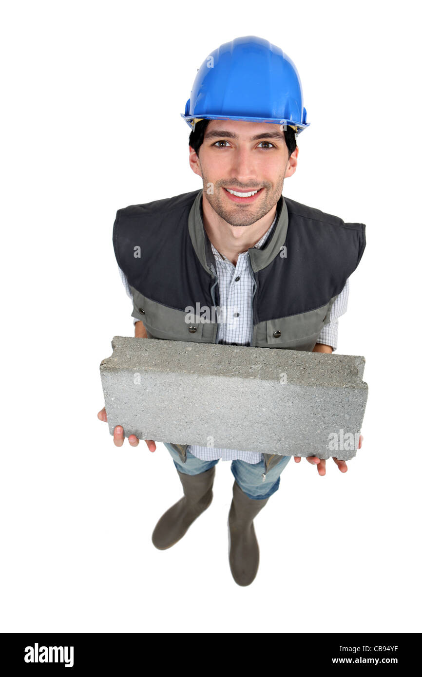Builder with a block in his hands Stock Photo Alamy