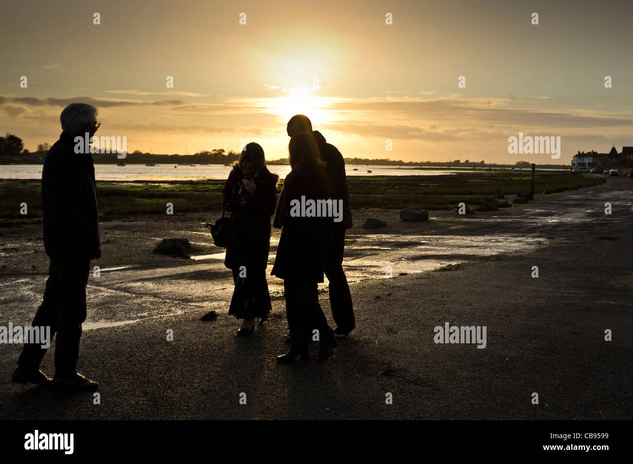 A group out walking near Bosham withthe sun setting behind Stock Photo
