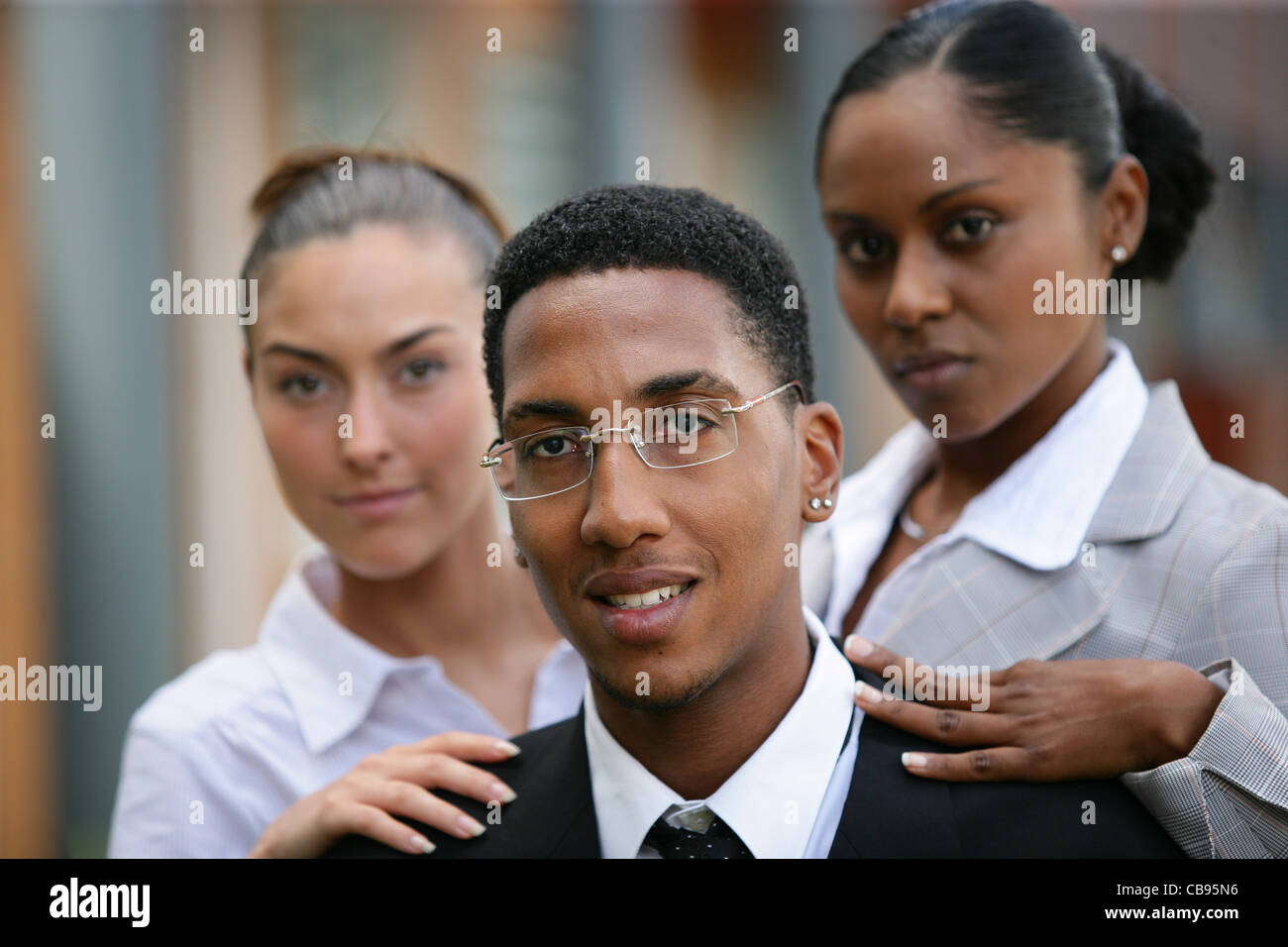 Women touching the shoulder of a man Stock Photo