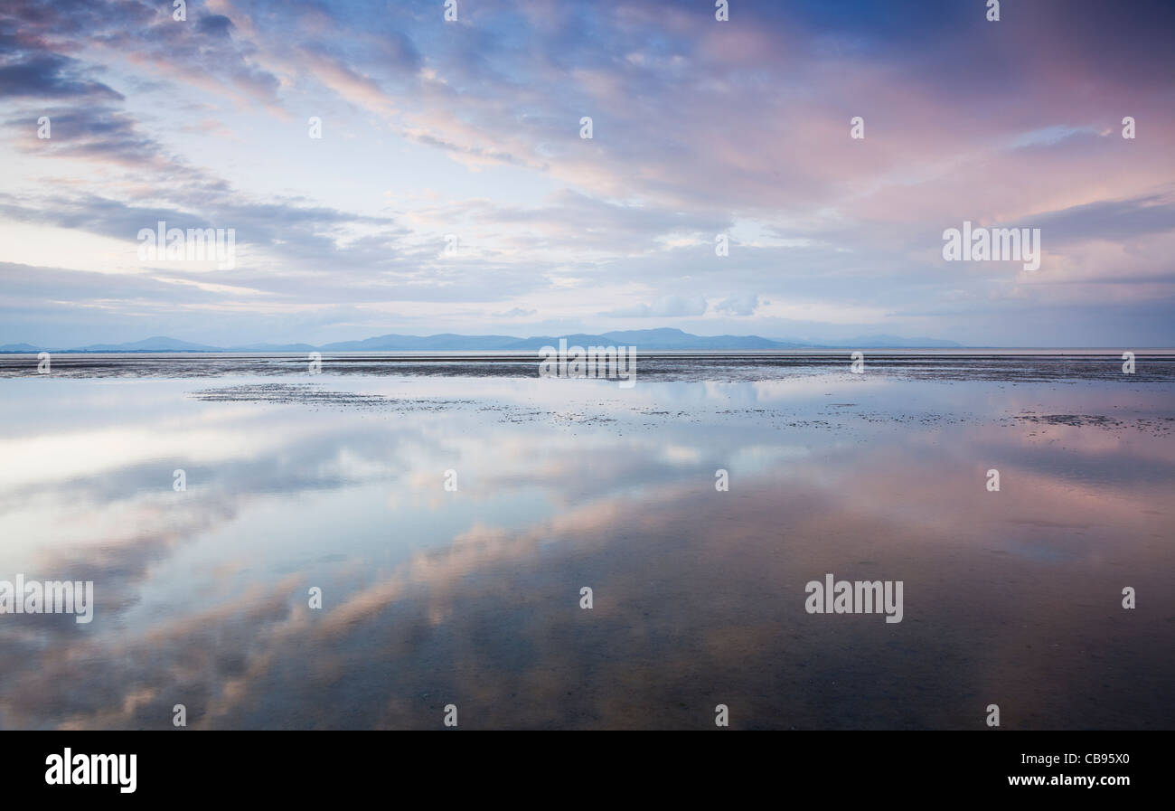 Evening over Dundalk Bay and the Cooley Mountains with clouds reflecting in the tidal pols Stock Photo