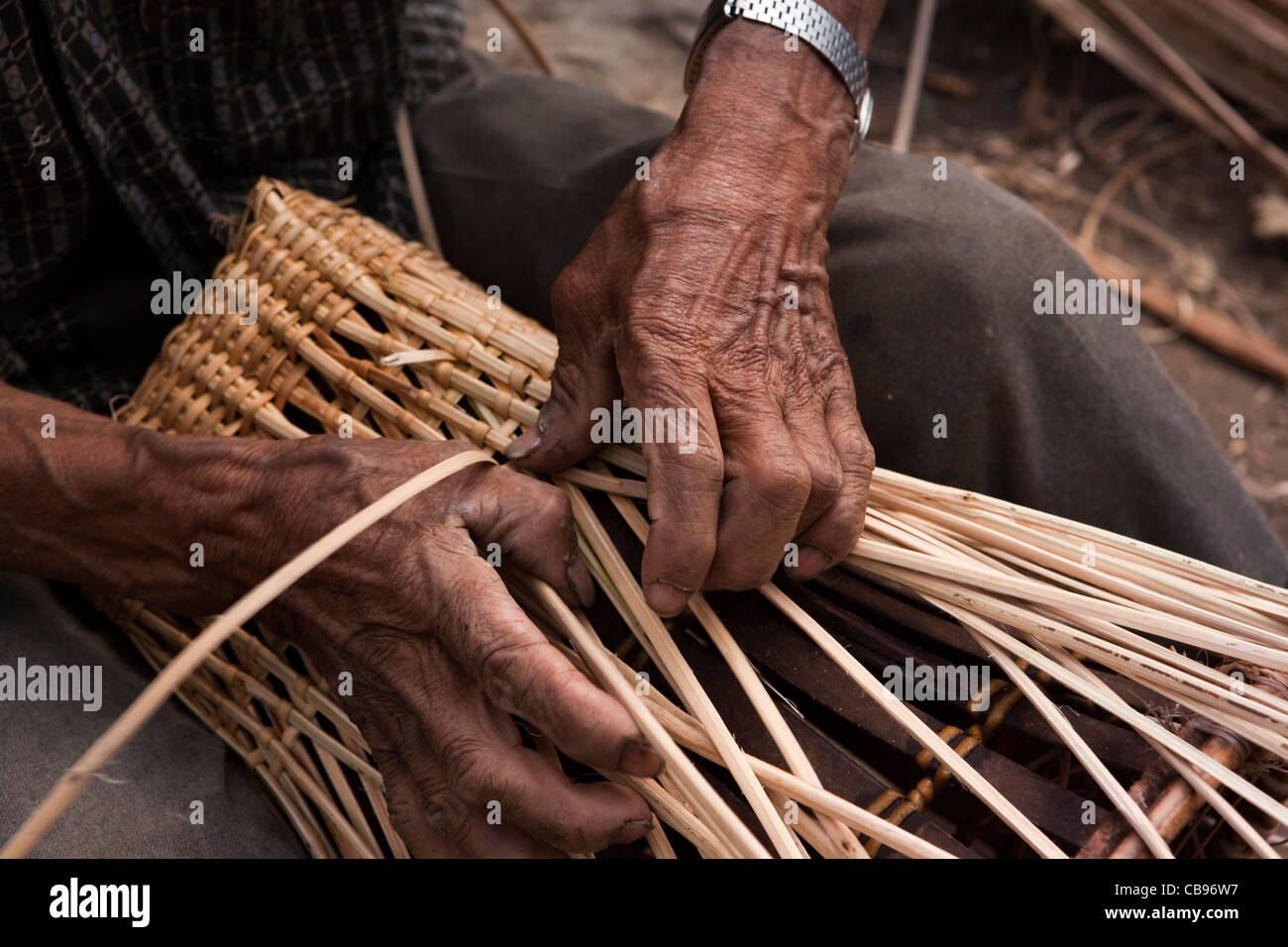 India, Nagaland, Khonoma, crafts, hands of old man weaving basket Stock Photo