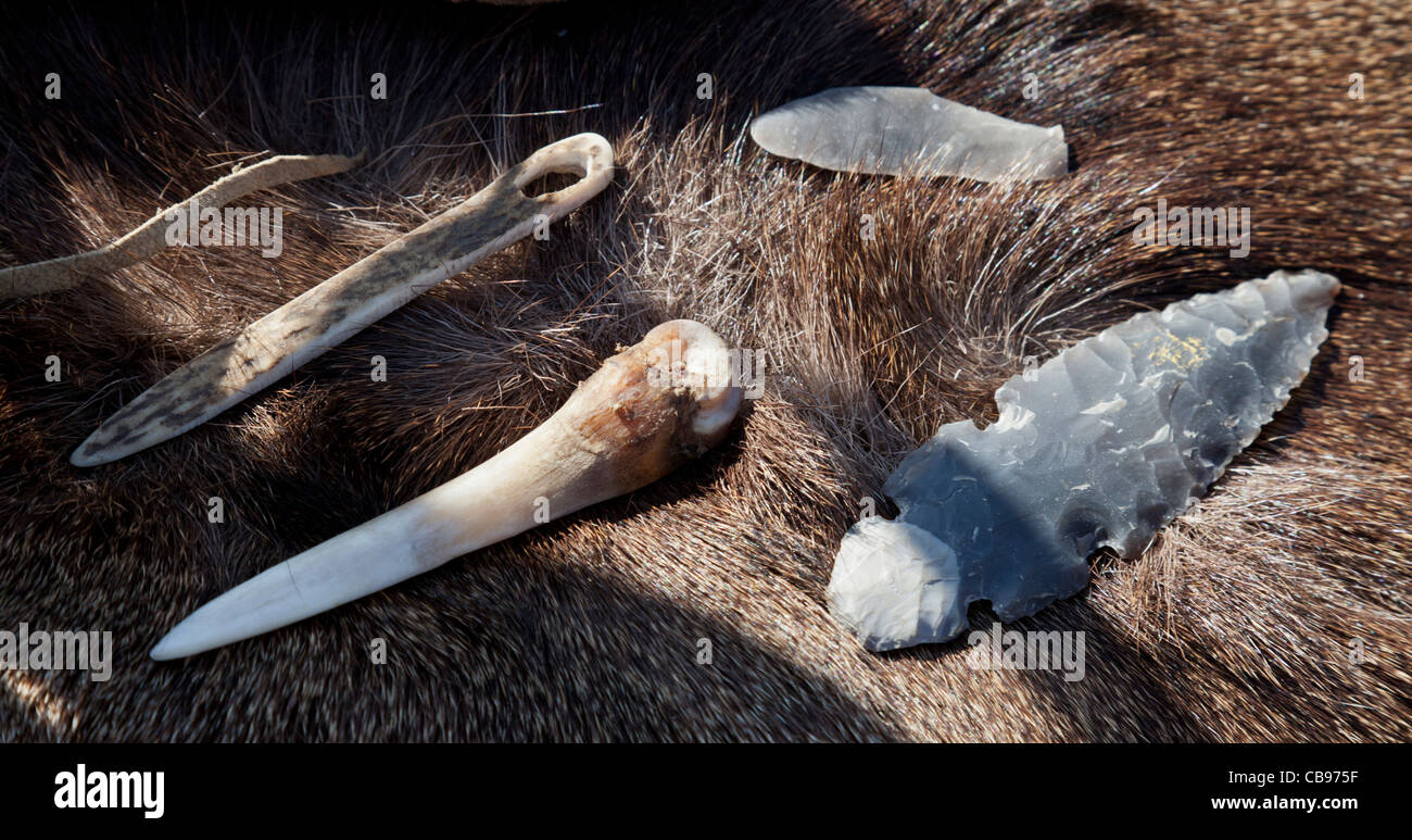 Tools for flint knapping and finished flint spearhead Stock Photo