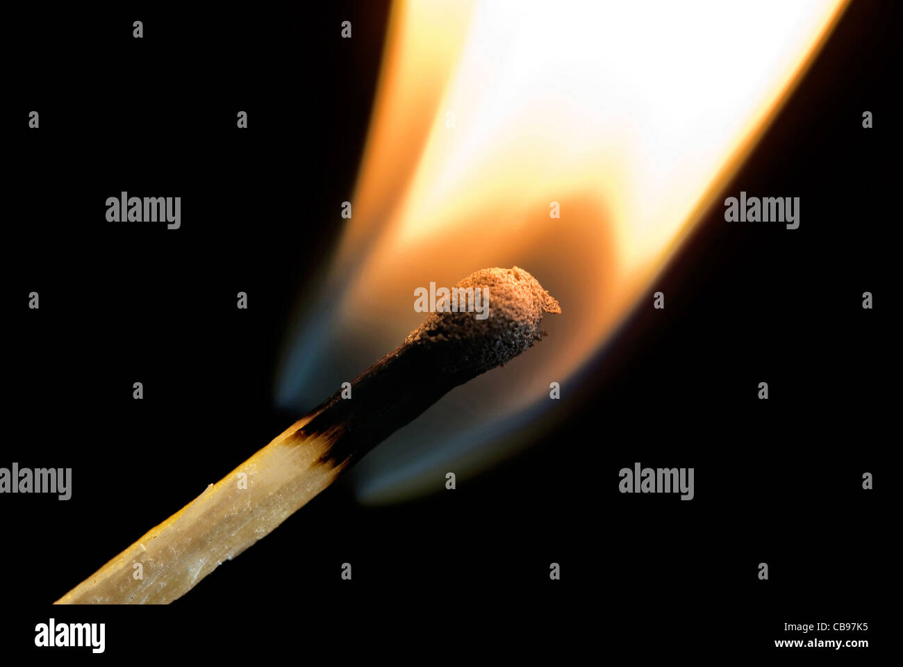 wooden matchstick igniting into flame against black background Stock ...