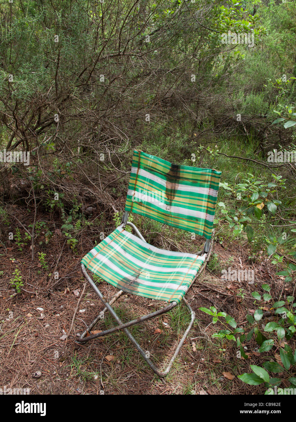 Abandoned camping chair in the bushes, Spain Stock Photo