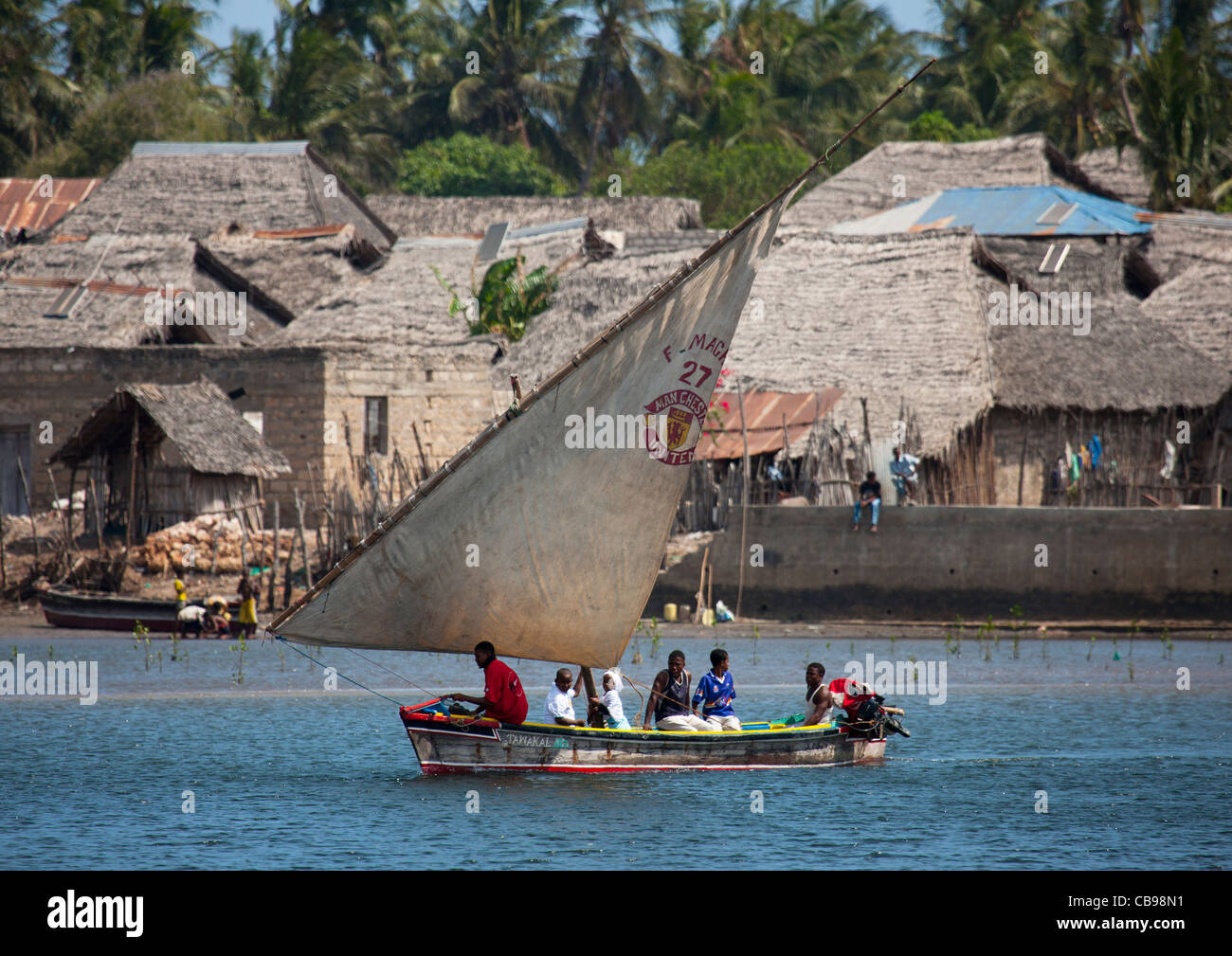 People navigating on a dhow boat near Lamu Stock Photo